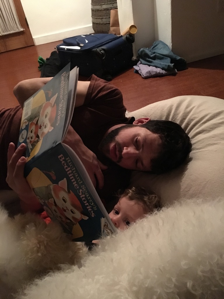 Snuggling to read before bedtime.  We try to read as a whole family every night so that Baby Pirate has a chance to hear daddy reading :)